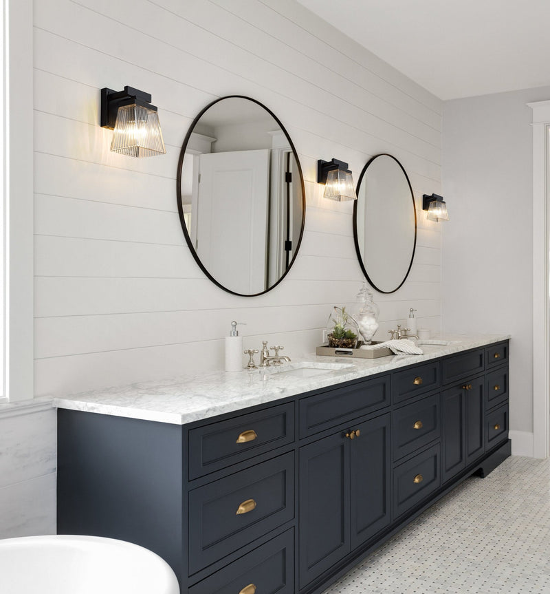 Astor 1 Light 5.75" Wall Sconce, Clear Shade in Matte Black in a room setting