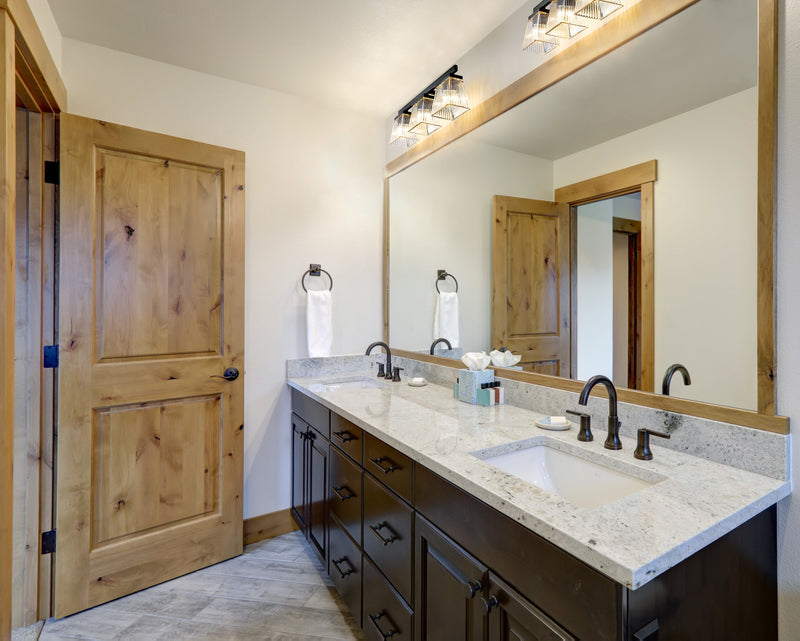 Astor 3 Light 23" Vanity, Clear Shade in Matte Black in a room setting
