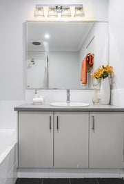 Astor 4 Light 29" Vanity, Clear Shade in Chrome in a room setting