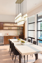 Cayden 23 Light 54" Linear Pendant in Modern Gold in a room setting