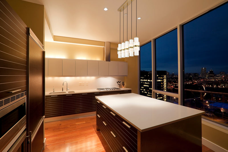 Cayden 5 Light 42" Linear Pendant in Modern Gold in a room setting