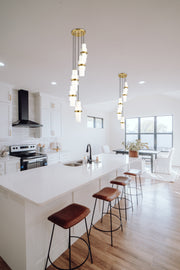 Cayden 5 Light 12" Pendant in Modern Gold in a room setting