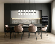 Cayden 7 Light 54" Linear Pendant in Matte Black in a room setting