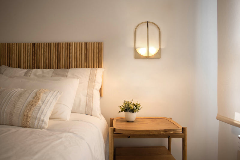 Devon 2 Light 12" Wall Sconce in Modern Gold in a room setting