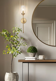 Cassian 1 Light 5.5" Wall Sconce in Modern Gold in a room setting