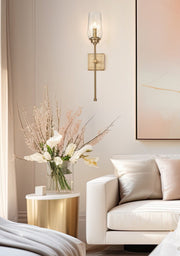 Cosmo 1 Light 5" Wall Sconce in Modern Gold in a room setting