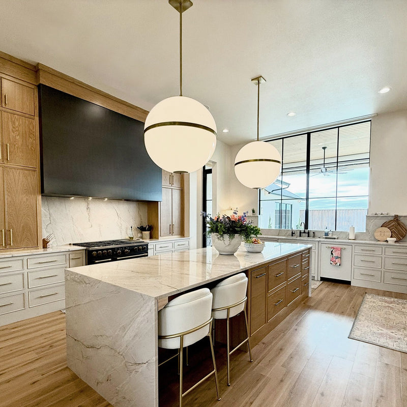 Truax 4 Light 30" Pendant in Aged Brass in a room setting