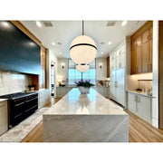 Truax 4 Light 30" Pendant in Aged Brass in a room setting