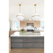 Truax 4 Light 30" Pendant in Aged Brass in a room setting