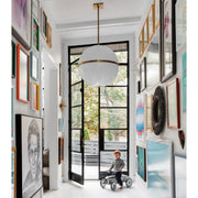 Truax 4 Light 30" Pendant in Aged Brass in a room setting