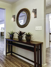 Wentworth 1 Light 4.5" Wall Sconce in Plated Bronze in a room setting