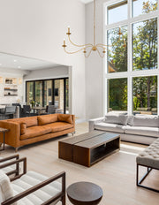 Arrington 6 Light 63" Chandelier in Rubbed Brass in a room setting