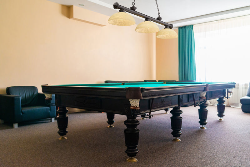 Cordon 3 Light 57.25" Billiard, Glass Shades (D) in Bronze in a room setting