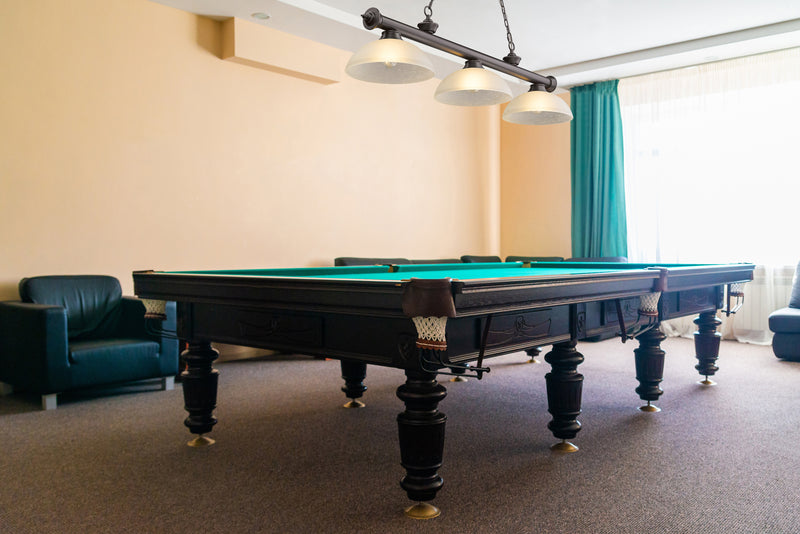 Cordon 3 Light 57.25" Billiard, Glass Shades (D) in Bronze in a room setting