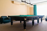 Cordon 3 Light 58" Billiard, Glass Shades in Bronze in a room setting