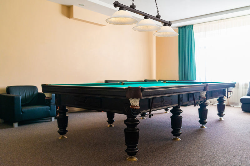 Cordon 3 Light 58" Billiard, Glass Shades in Bronze in a room setting