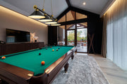 Cordon 4 Light 81.25" Billiard, Matte Black + Rubbed Brass with Matte Black Shades in Matte Black + Rubbed Brass in a room setting