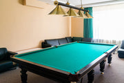 Cordon 4 Light 81.25" Billiard, Matte Black + Rubbed Brass with Rubbed Brass Shades (4MB-RB-RB15) in Matte Black + Rubbed Brass in a room setting