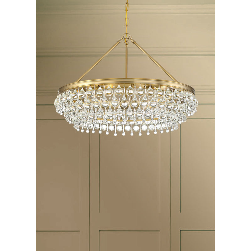 Calypso 6 Light 30" Chandelier in Vibrant Gold in a room setting