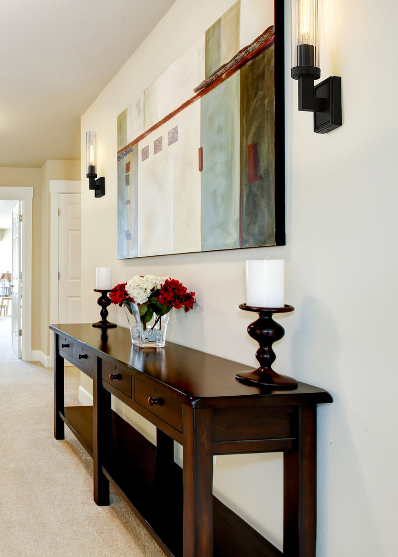 Beau 1 Light 4.5" Wall Sconce, Clear Shade in Bronze in a room setting