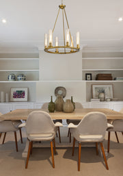Beau 6 Light 26" Chandelier in Rubbed Brass in a room setting
