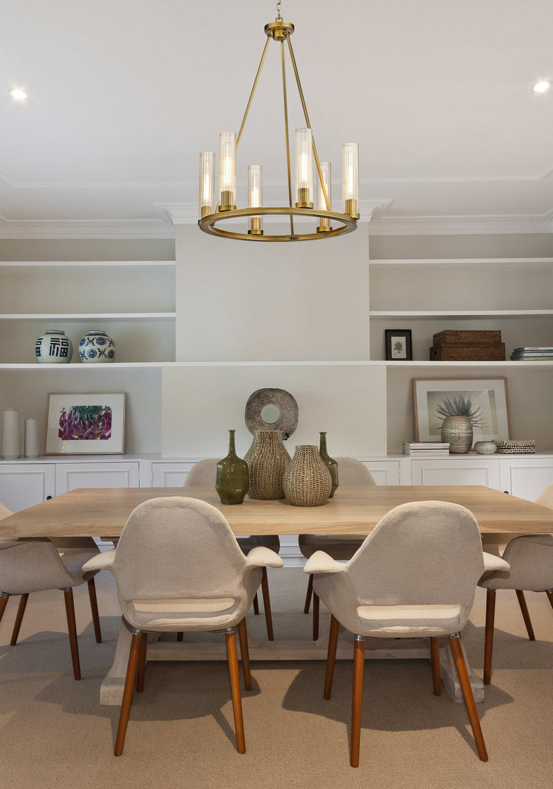 Beau 6 Light 26" Chandelier in Rubbed Brass in a room setting