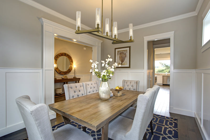 Beau 7 Light 44" Linear Pendant in Rubbed Brass in a room setting