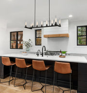 Beau 9 Light 56" Linear Pendant in Bronze in a room setting