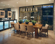 Beau 9 Light 56" Linear Pendant in Rubbed Brass in a room setting