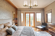 Callista 3 Light 28" Chandelier in Rubbed Brass in a room setting