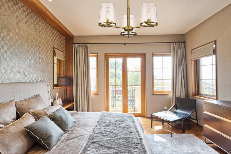 Callista 3 Light 28" Chandelier in Rubbed Brass in a room setting
