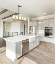 Emily 5 Light 51" Linear Pendant in Rubbed Brass in a room setting