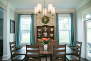Emily 5 Light 28" Chandelier in Rubbed Brass in a room setting