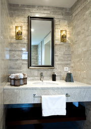 Fontaine 1 Light 4.75" Wall Sconce in Rubbed Brass in a room setting