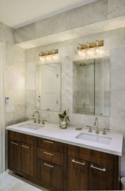 Fontaine 3 Light 24" Vanity in Rubbed Brass in a room setting
