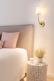 Shannon 1 Light 5.25" Wall Sconce in Rubbed Brass in a room setting