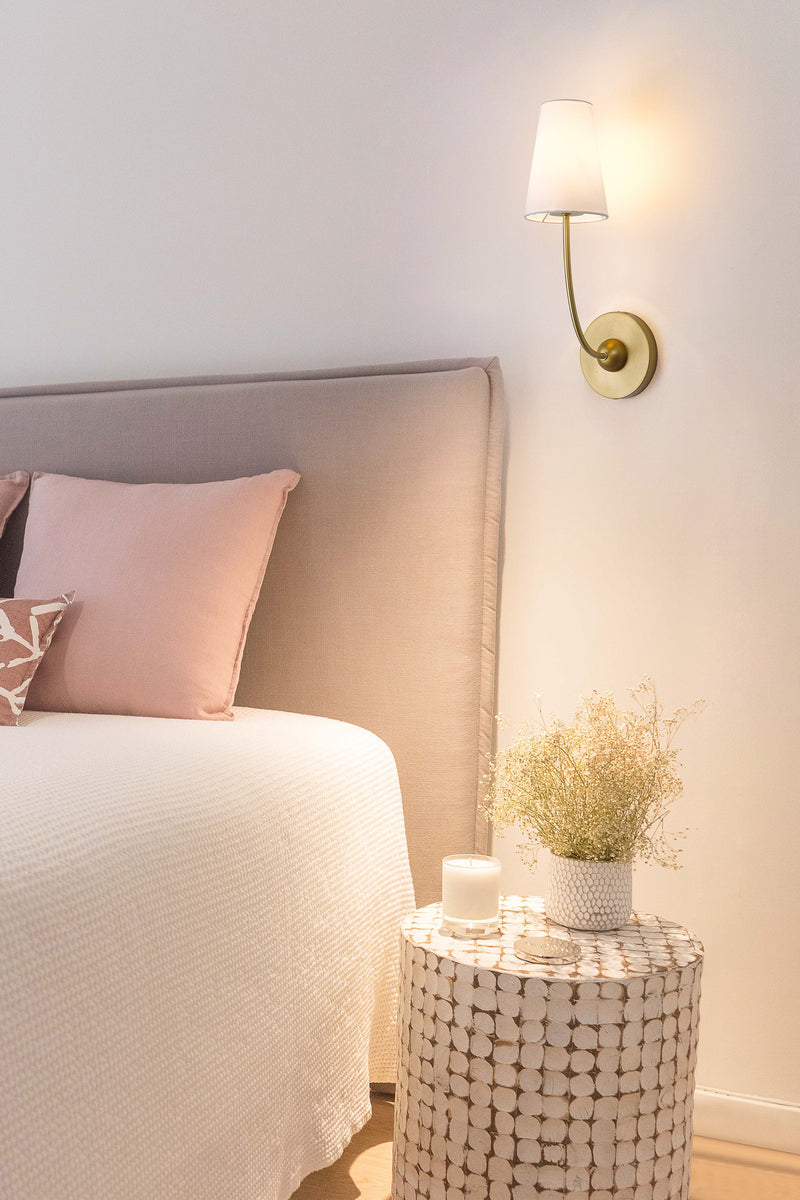 Shannon 1 Light 5.25" Wall Sconce in Rubbed Brass in a room setting