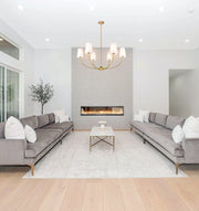 Shannon 6 Light 42" Chandelier in Rubbed Brass in a room setting