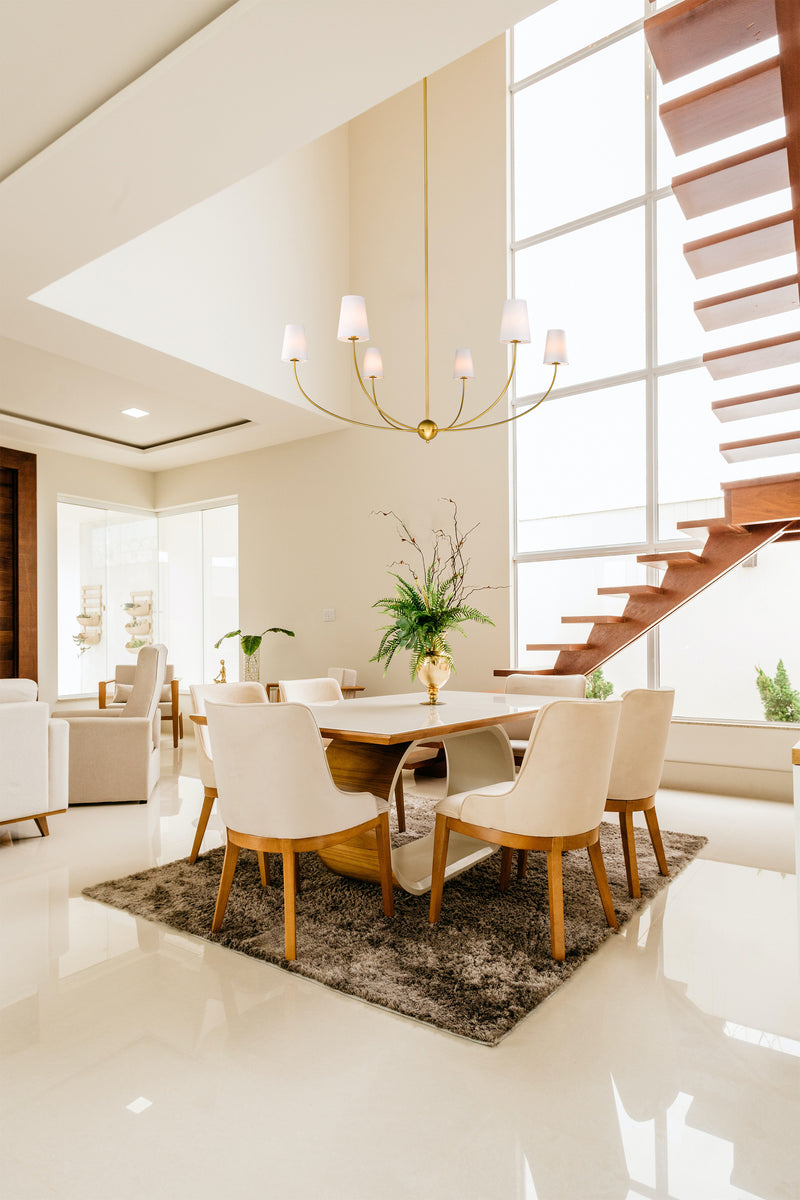 Shannon 6 Light 62" Chandelier in Rubbed Brass in a room setting