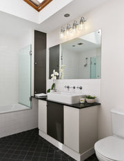Kinsley 4 Light 28" Vanity in Chrome in a room setting