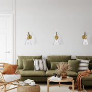 Gayson 1 Light 7.75" Wall Sconce in Rubbed Brass in a room setting