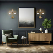 Allistair 3 Light 15" Wall Sconce in Modern Gold in a room setting