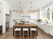 Dennison 6 Light Chandelier in Signature Brass in a room setting