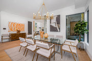 Dennison 8 Light 36" Chandelier in Signature Brass in a room setting