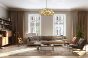 Garroway 9 Light 32" Chandelier in Aged Brass in a room setting