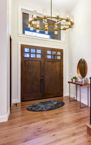 Datus 12 Light 43.5" Chandelier in Rubbed Brass in a room setting