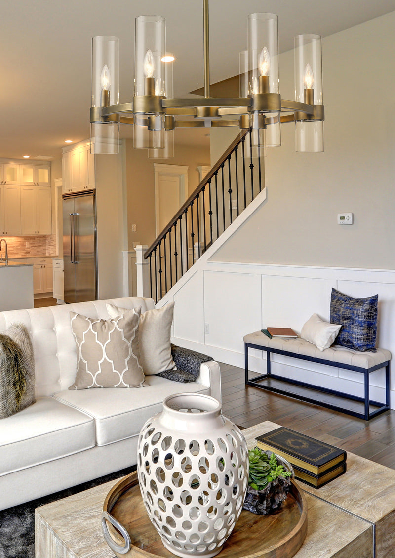 Datus 6 Light 26" Chandelier in Rubbed Brass in a room setting