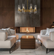 Datus 8 Light 32" Chandelier in Rubbed Brass in a room setting