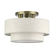Manorwood 3-Light 15" Semi-Flush Mount with Oatmeal Shade in Antique Brass