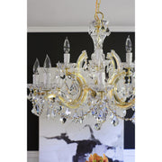 Maria Theresa 12 Light 29" Chandelier in Gold in a room setting
